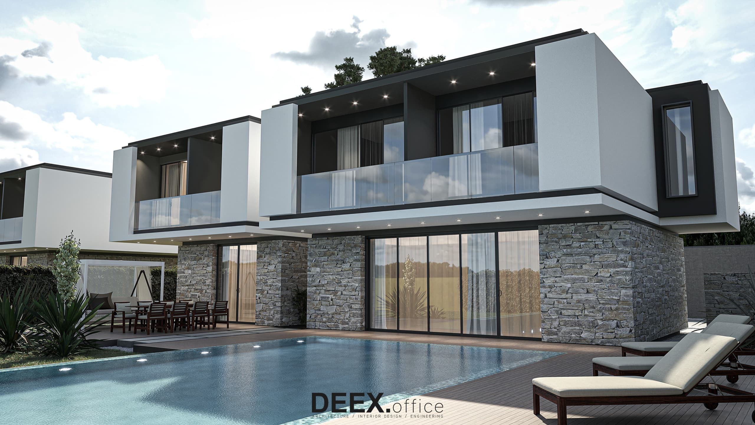 Pool deck looking back to the villa with floor-to-ceiling glass at twilight