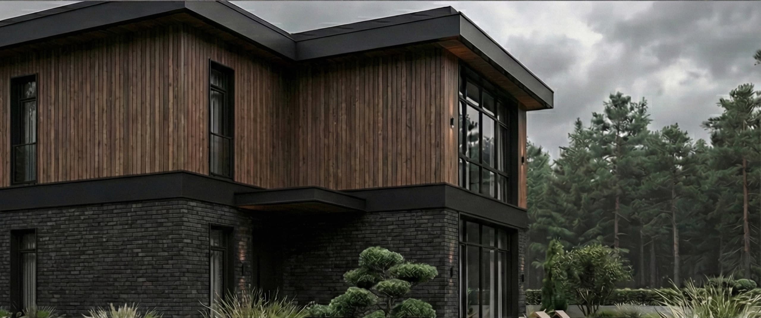Front elevation of villa under overcast sky framed by pine trees