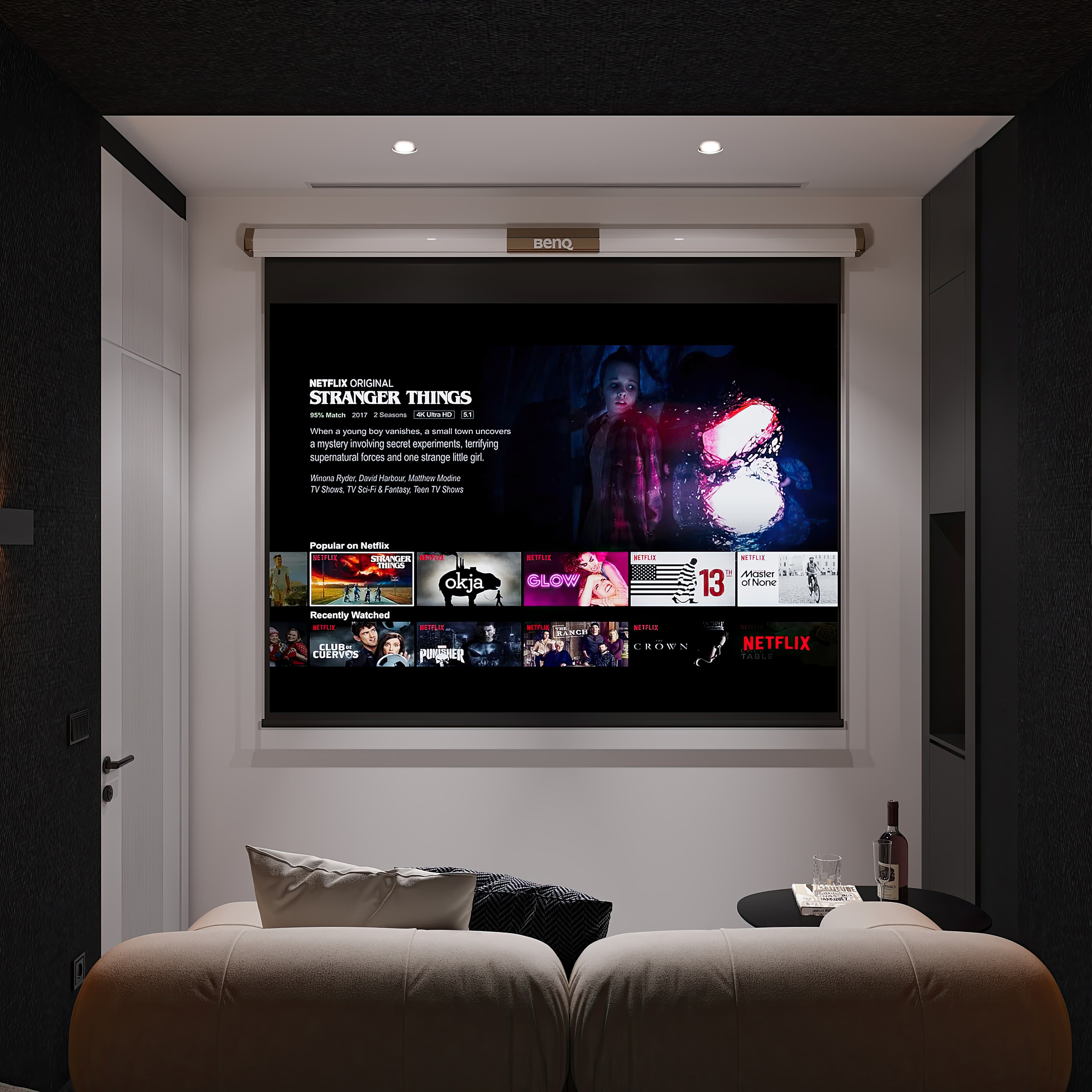 Cinema room with projector screen showing content and dark walls