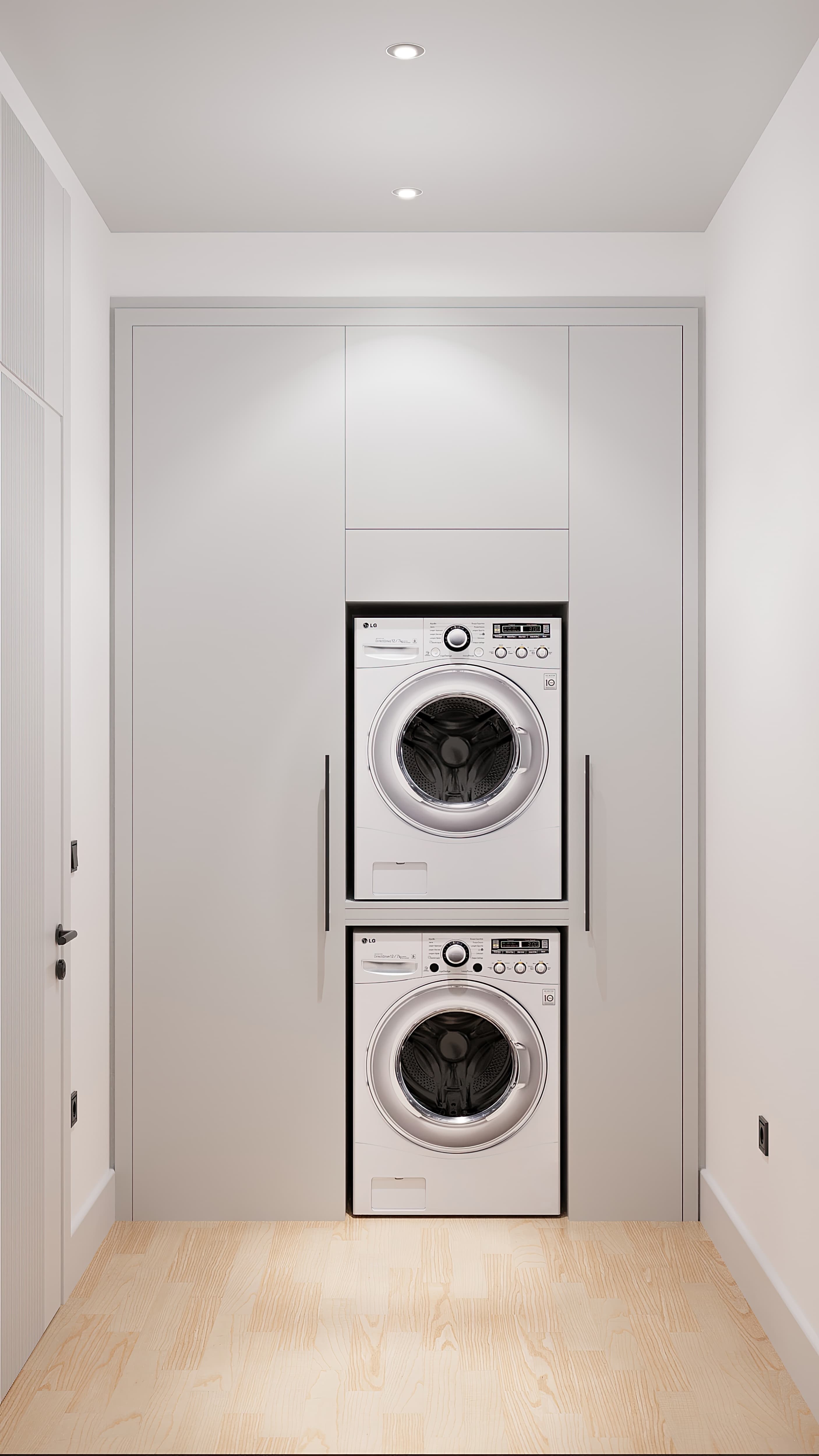 Laundry niche with stacked washer and dryer in white built-in cabinetry