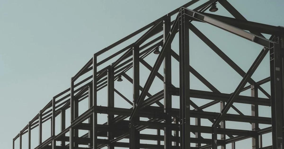 Split view of reinforced concrete structure and steel frame building under construction