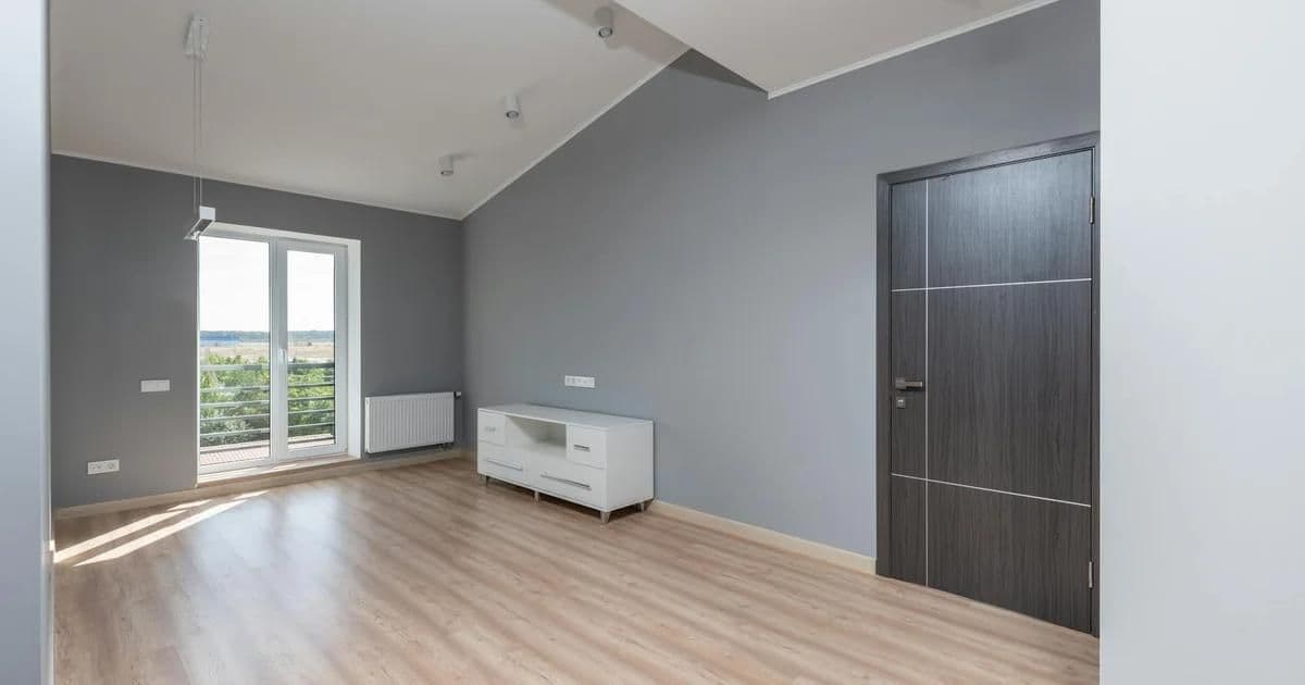 Minimalist interior design in a bright small apartment with built-in storage and natural light