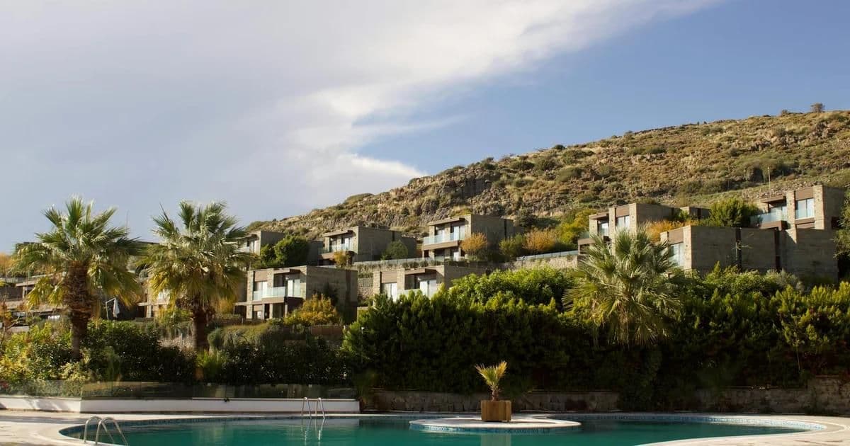 Mediterranean modern villa with clean lines, stone walls, and indoor-outdoor living spaces