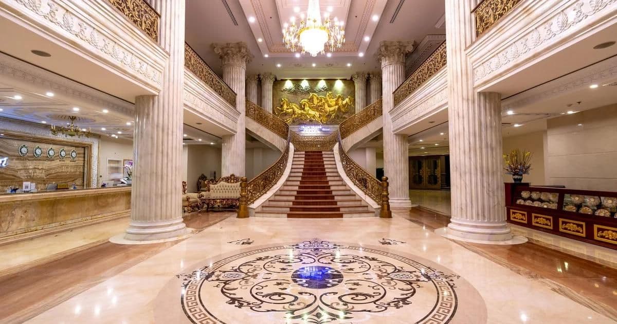 Luxurious hotel lobby interior with dramatic lighting, natural stone, and open social seating