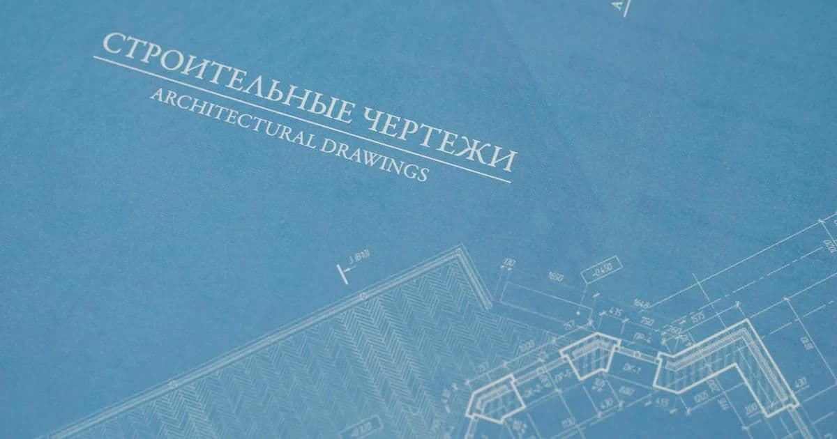 Architectural design brief document with floor plan sketches and project notes on a desk
