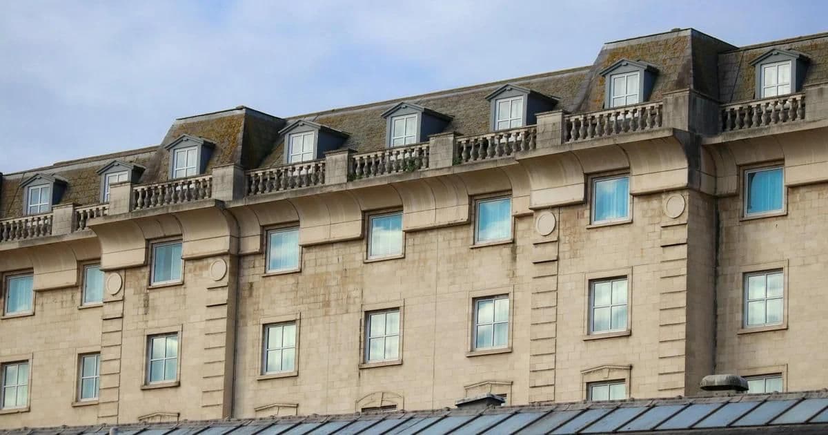 Natural stone cladding detail on a modern building exterior showing limestone panel installation